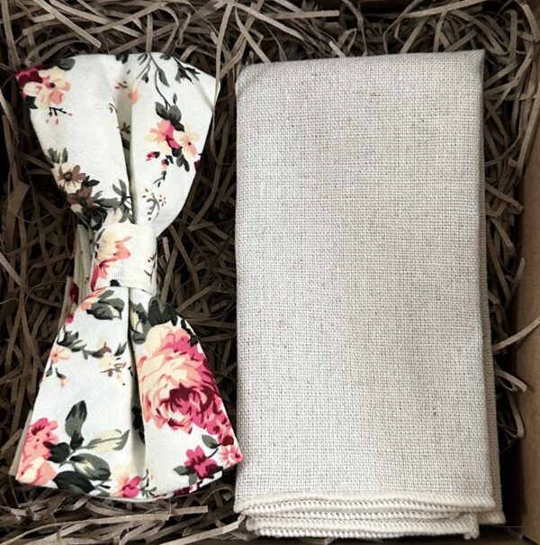 A photo of a pink floral cotton bow tie and a flax linen pocket square
