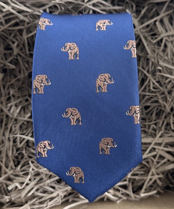 A photo of a mans tie with a elephant pattern on a blue background ideal as a mans gift