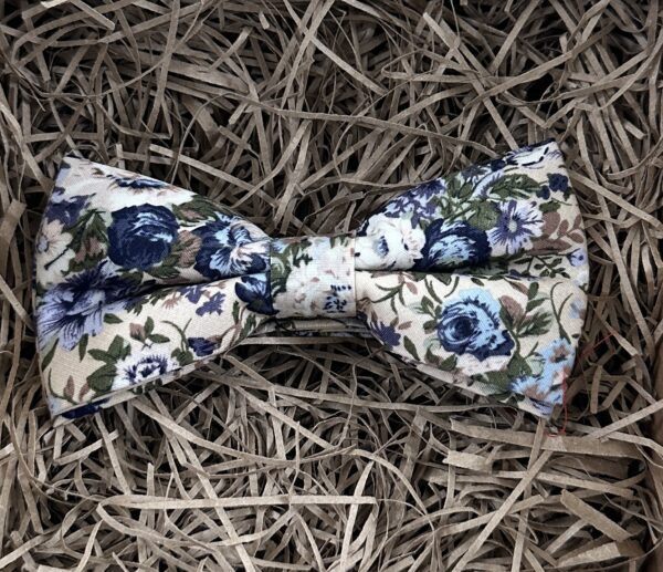 A photo of a blue floral pre-tied bow tie in cotton