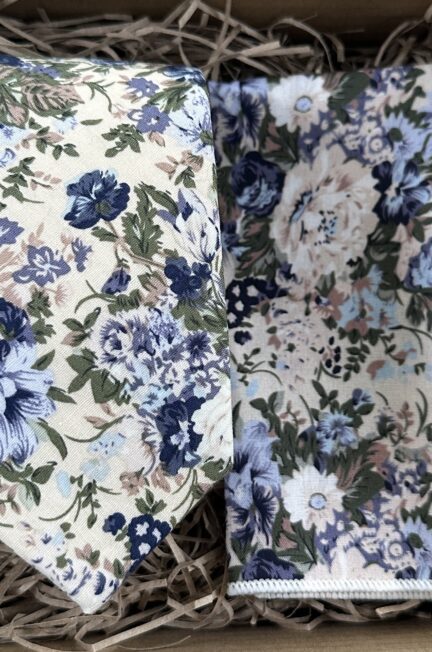 A photo of a blue floral tie and pocket square set in cotton