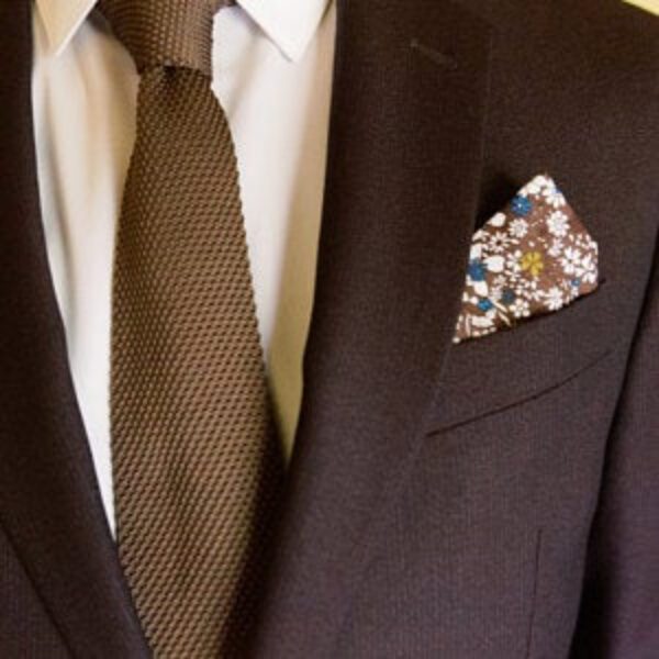 Brown knit tie and floral pocket square set.