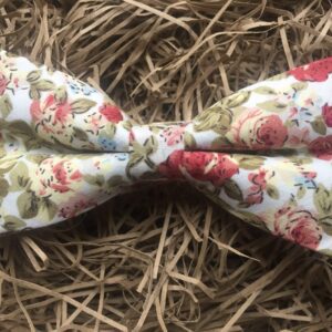 A photo of a pink rose floral bow tie in cotton