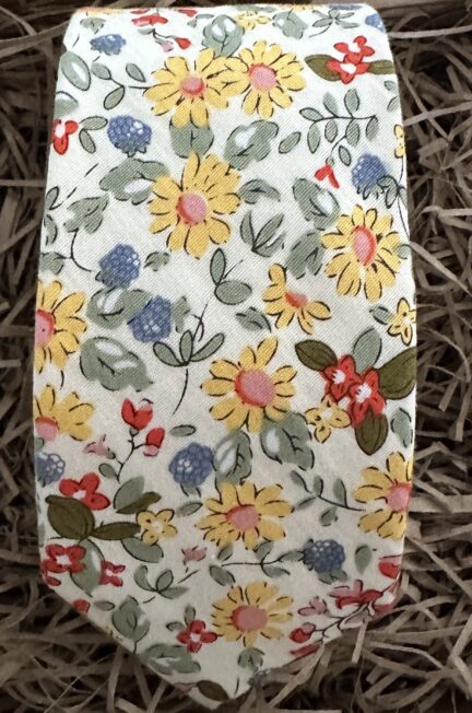 This is a yellow floral men’s tie on an ivory background.