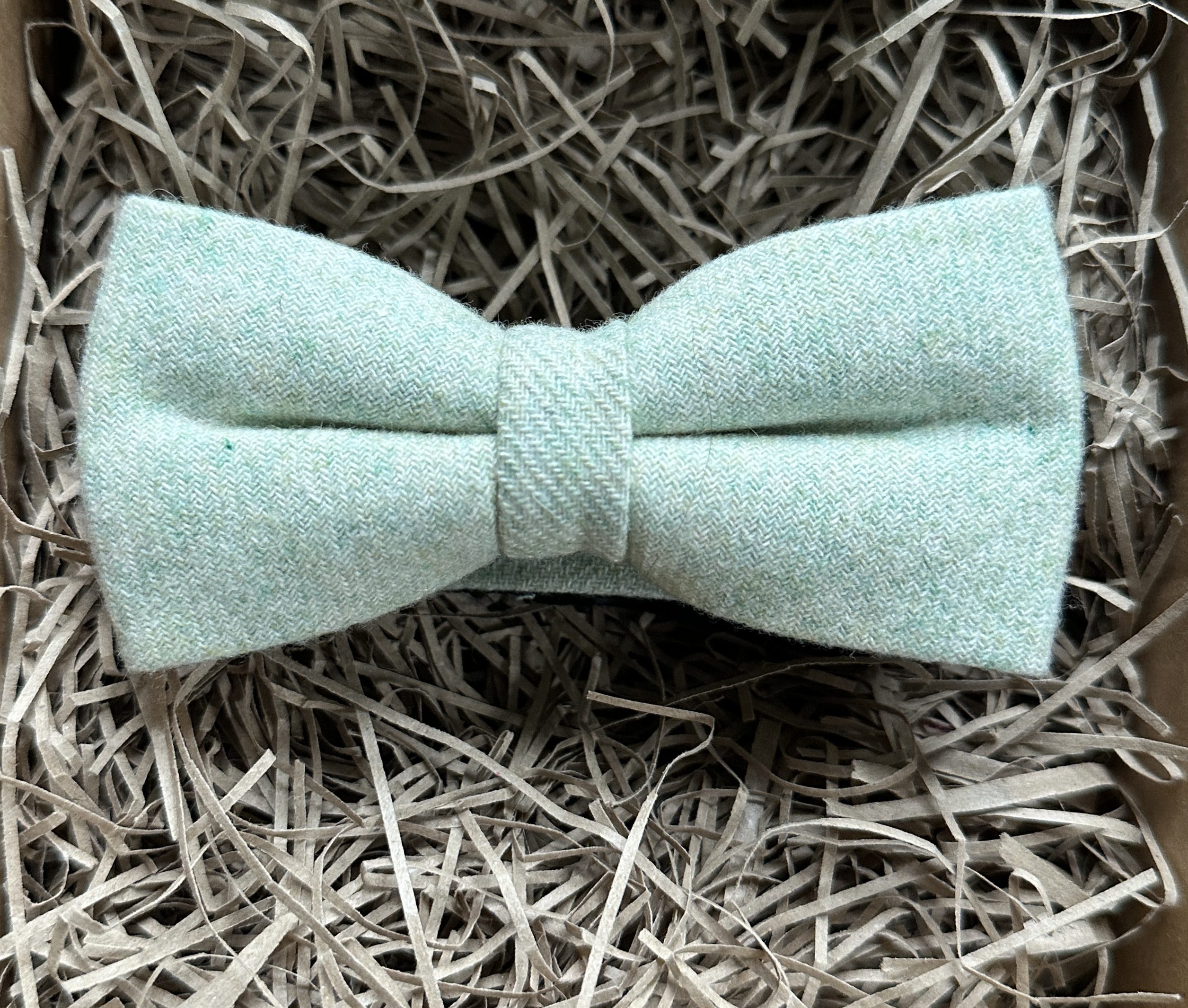 A light green wool bow tie which is pre-tied and ideal for weddings