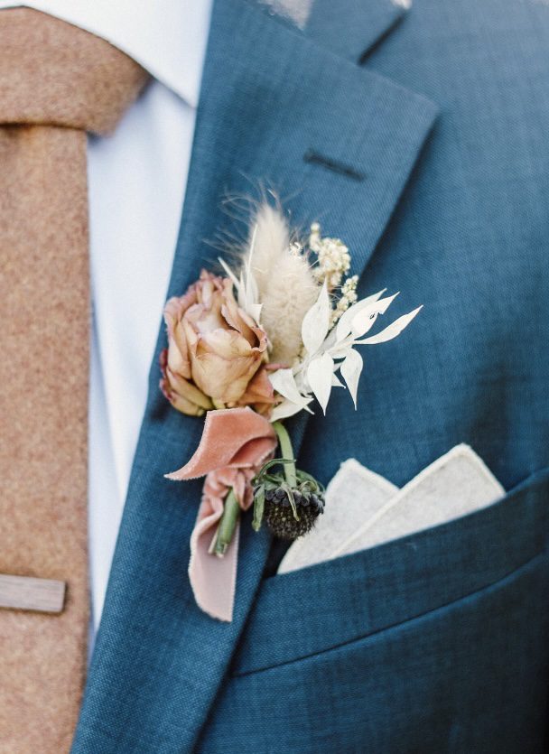 A groom wearing a camel brown wool tie