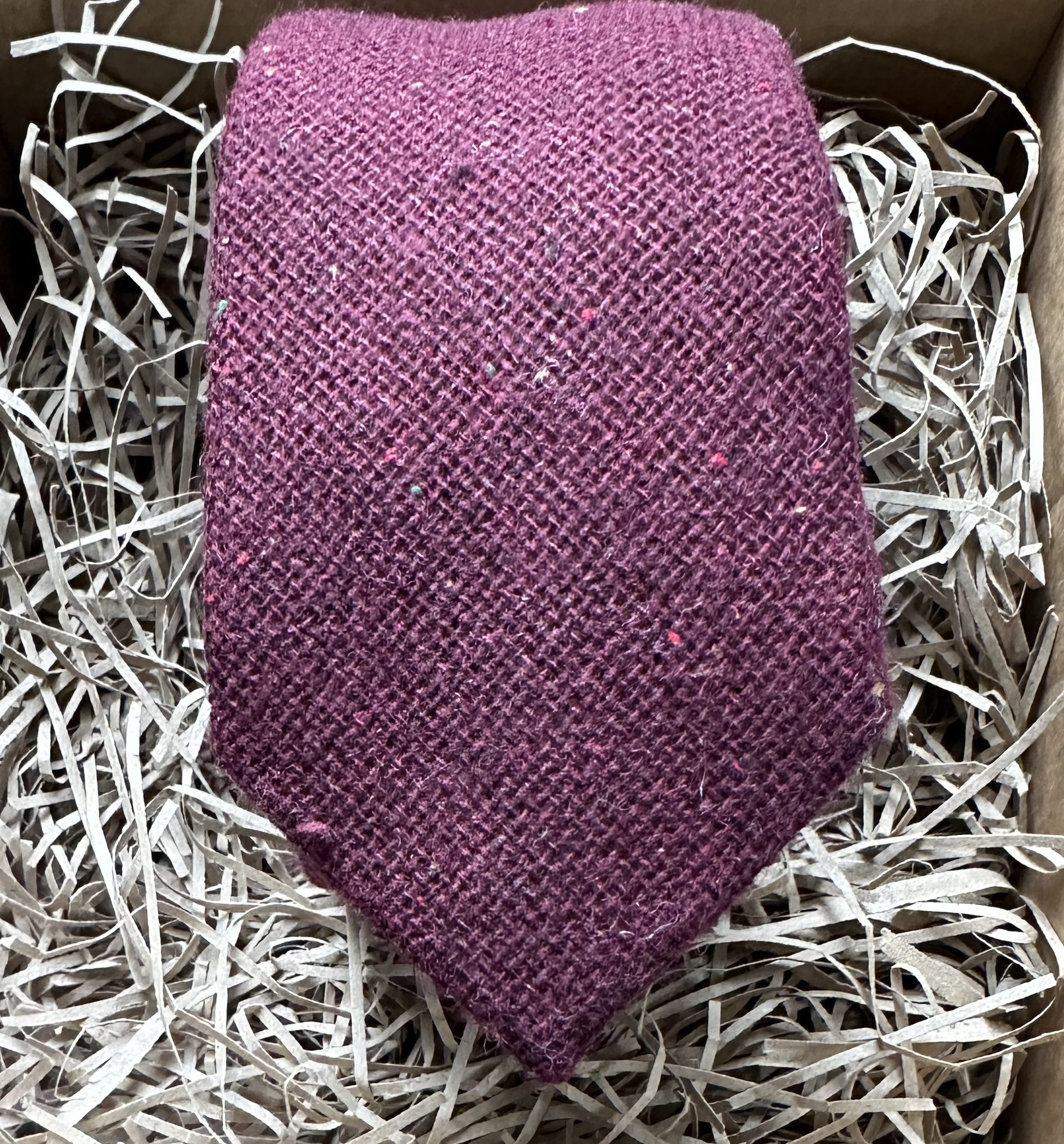 A burgundy red mens wool tie with flecks woven into the fabric. Ideal for mens gifts and groomsmen gifts