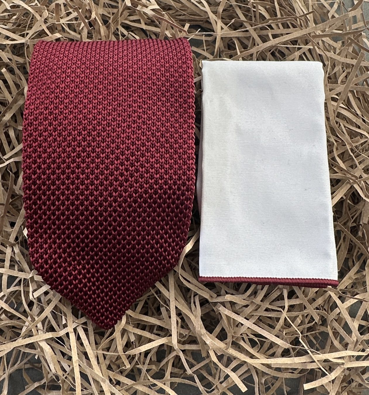 A red knitted mens tie and white pocket handkerchief gift set or wedding attire