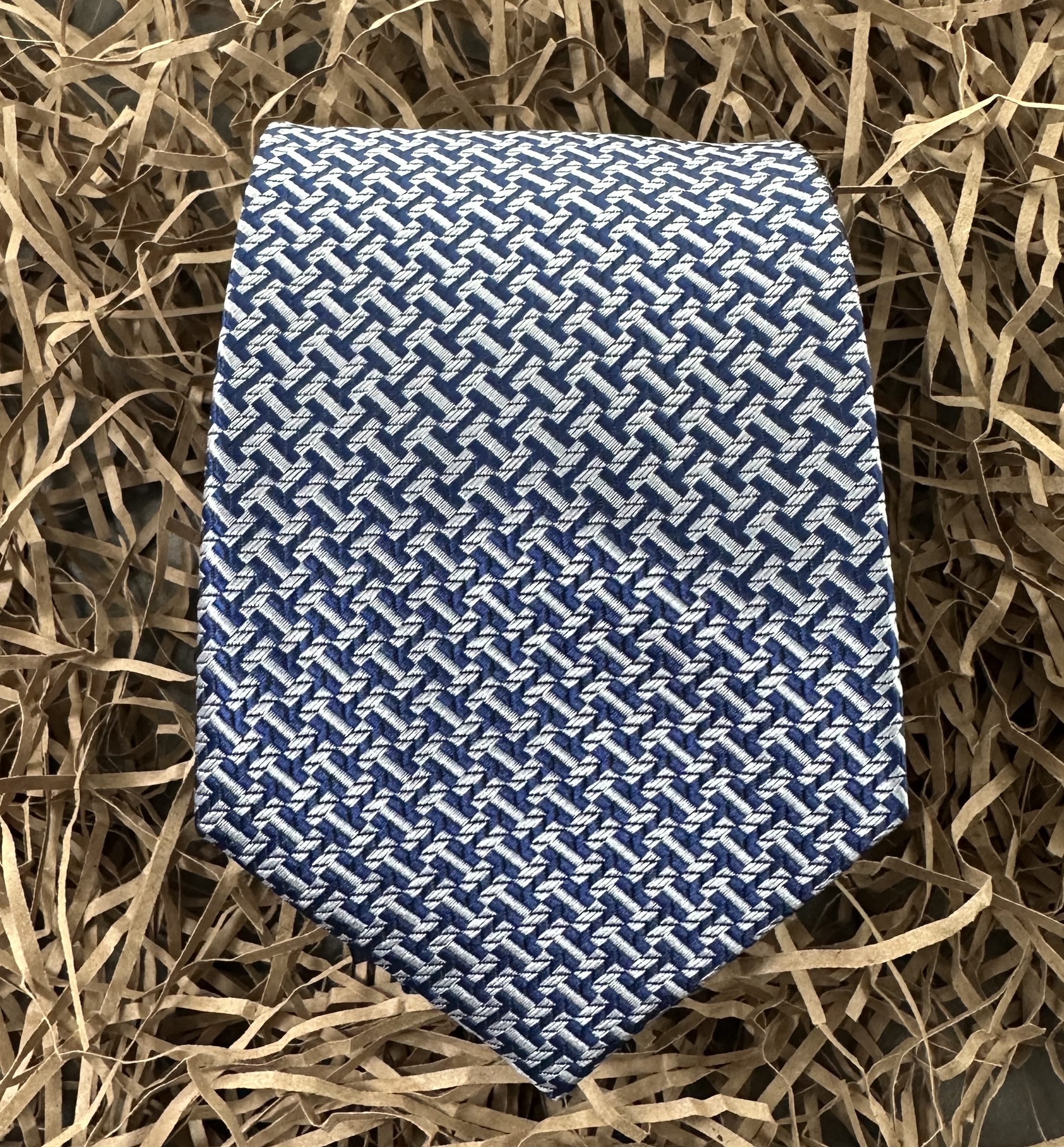 A blue and silver men's wide tie for formal occasions.