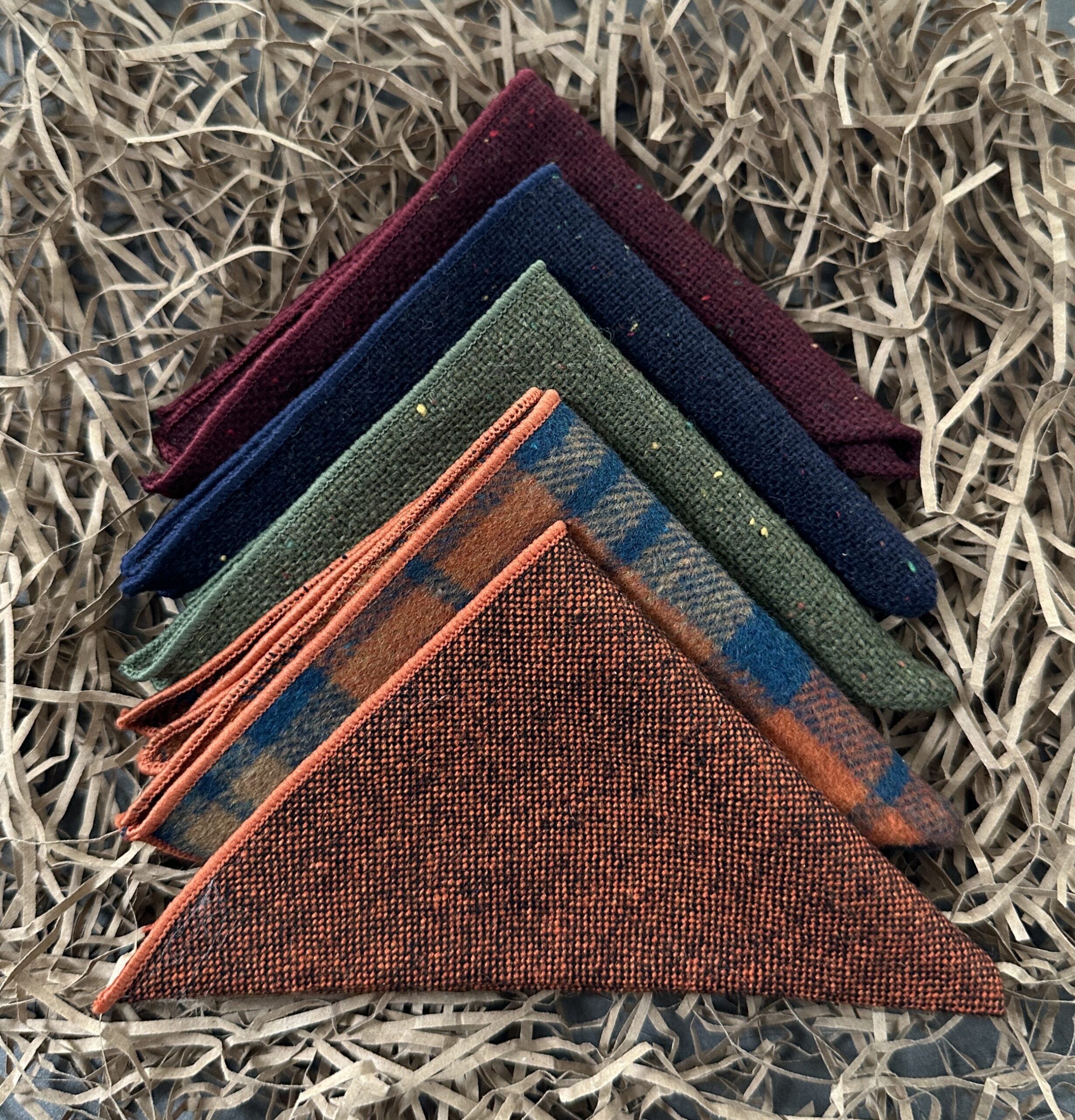 A set of five wool pocket squares in wool for men's gifts, groomsmen gifts and unique best man gifts.