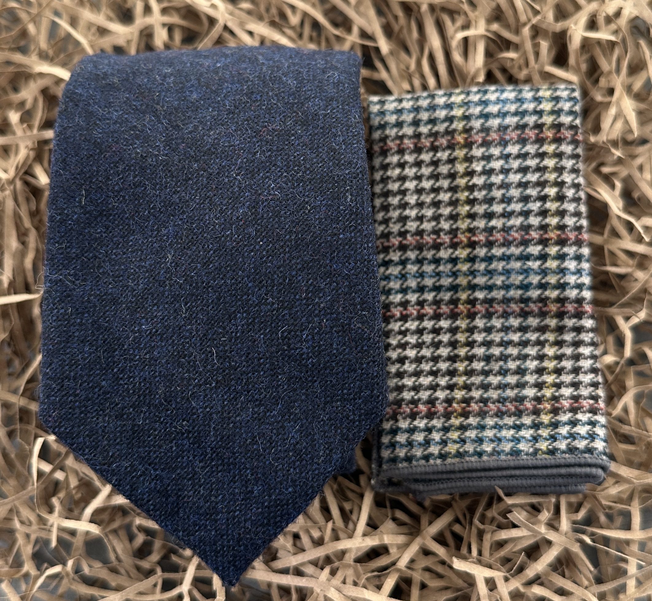 A navy blue mens wool tie and check pocket square. Ideal for mens gifts and groomsmen gifts.